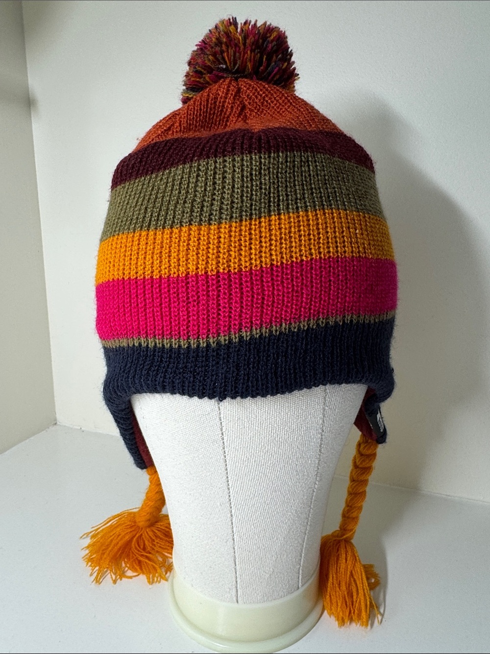 Kids REI acrylic knit beanie hat with pompom and ear flaps.